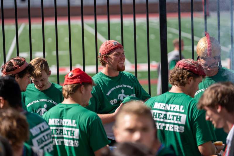 a group of men wearing green shirts