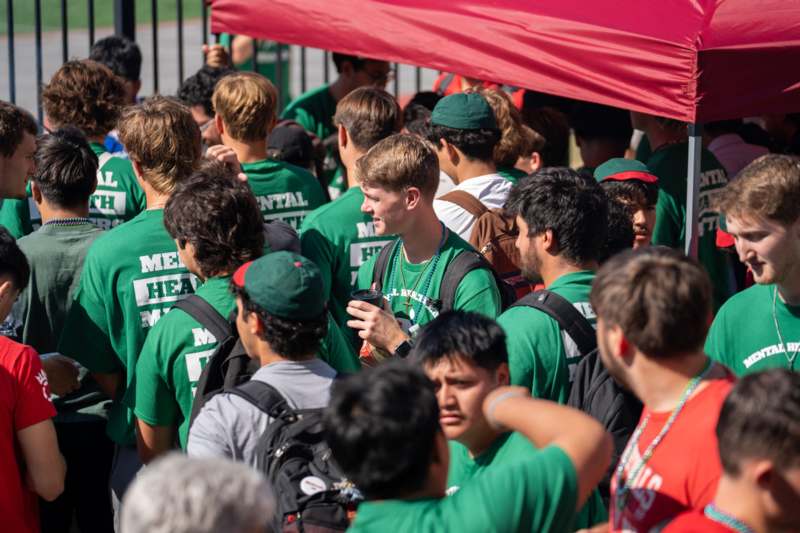 a group of people in green shirts
