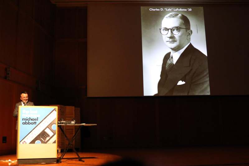 a man in a suit and tie on a stage