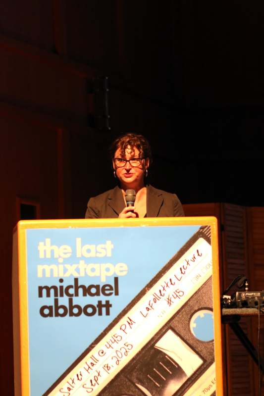a woman standing at a podium with a microphone