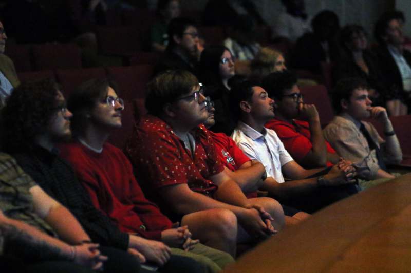 a group of people sitting in a theater