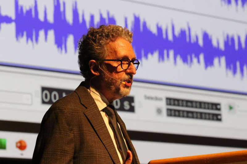 a man standing in front of a screen