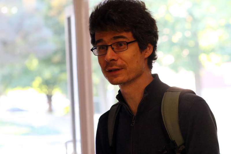 a man wearing glasses and a backpack