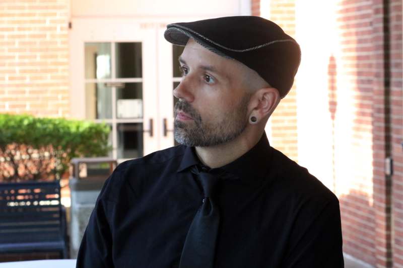 a man in a black shirt and tie
