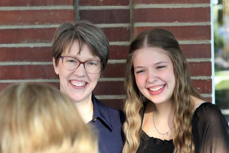 a woman and a girl smiling