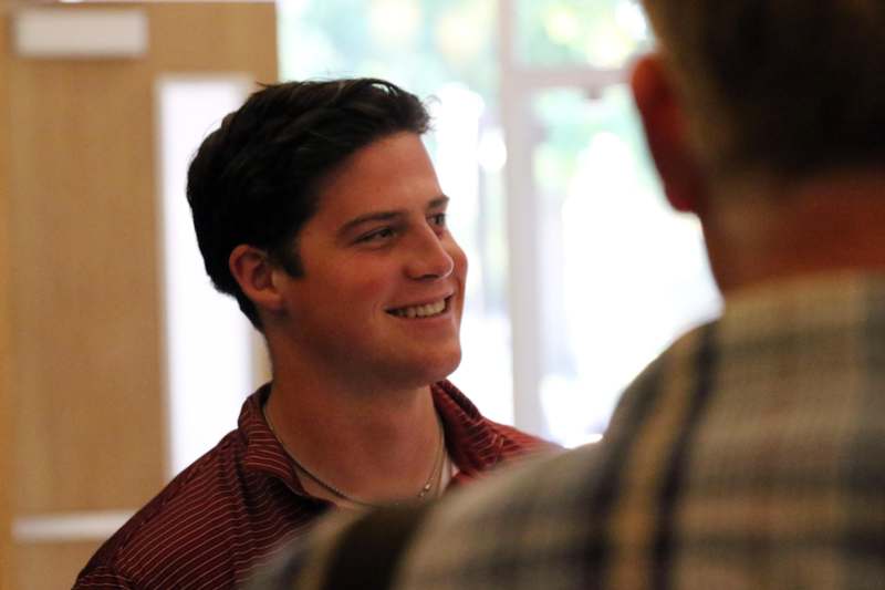 a man smiling at another man