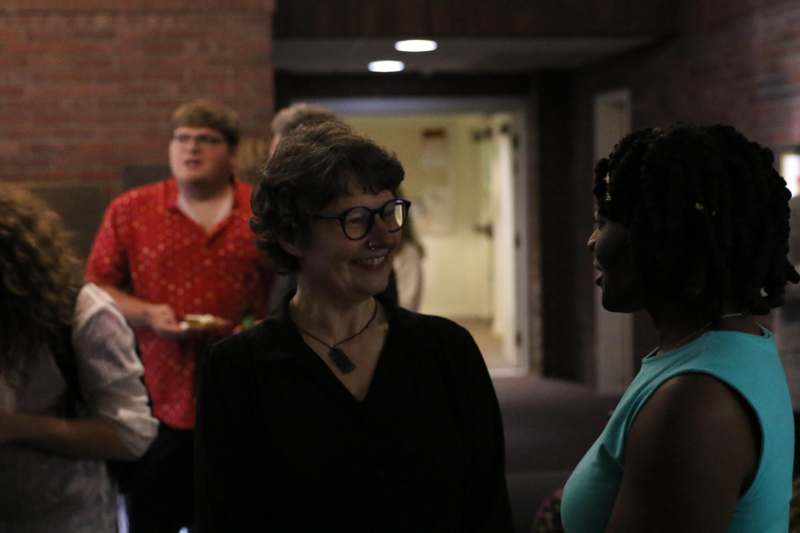 a group of people standing in a hallway