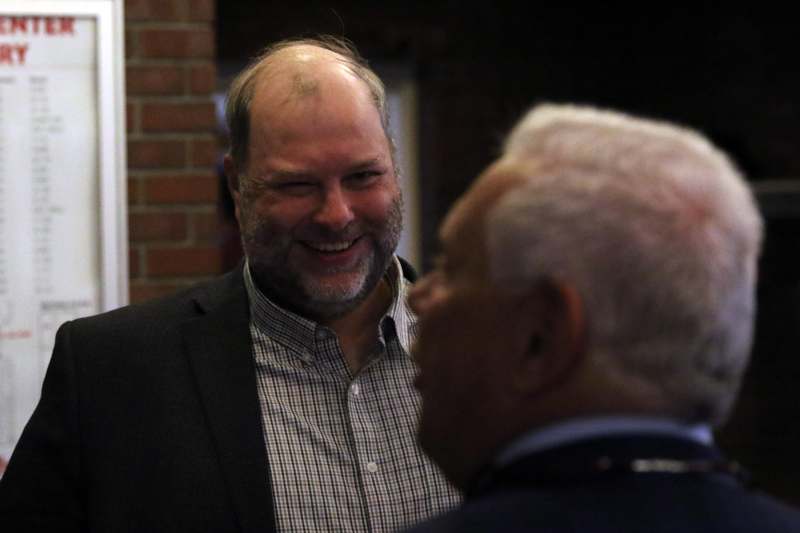 a man in a suit laughing