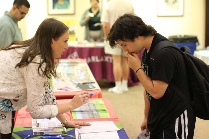 a man and woman looking at papers