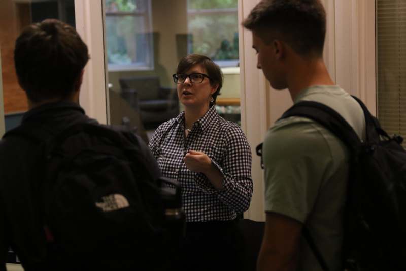 a woman talking to a group of people