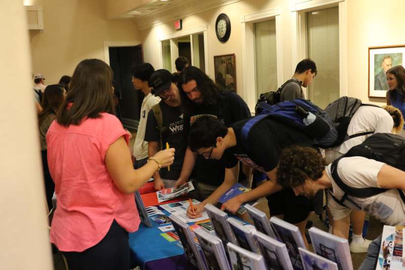 a group of people looking at a book