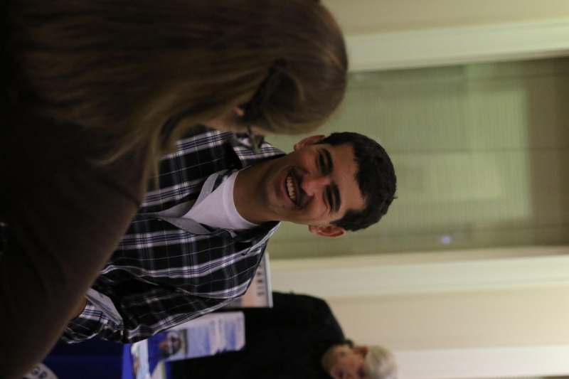 a man smiling at a woman