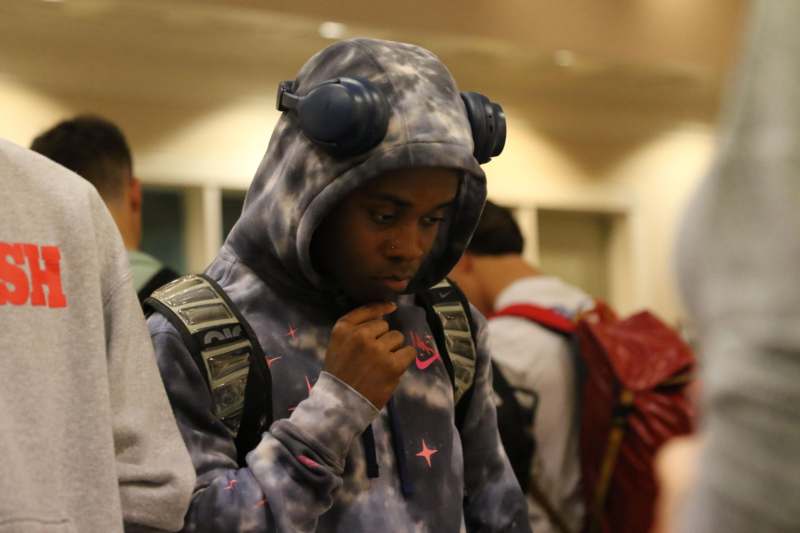 a man wearing a hoodie and headphones