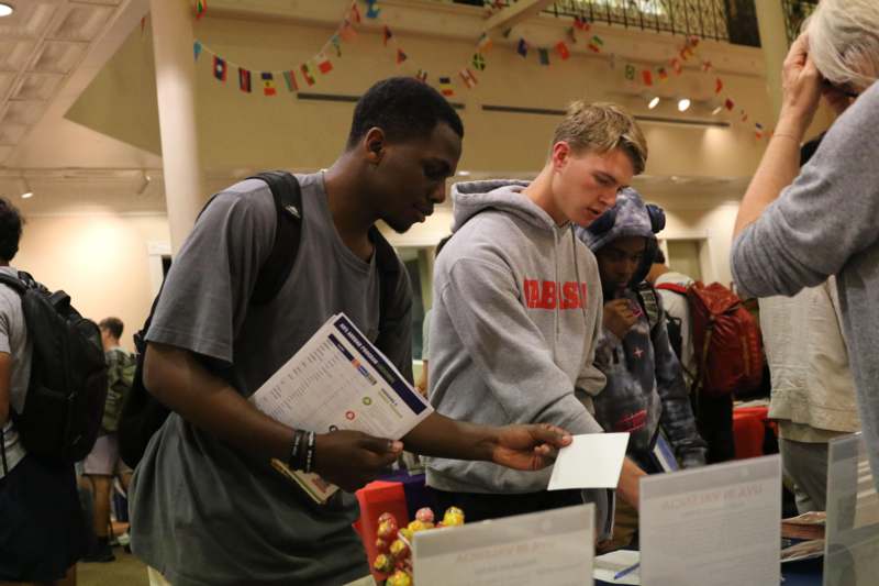 a group of men looking at a piece of paper
