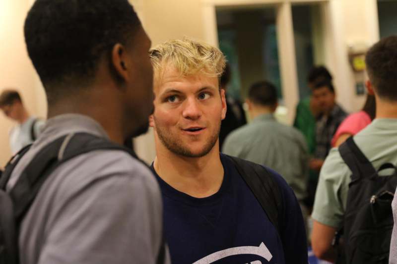 a man talking to another man