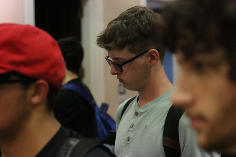a man wearing glasses and a backpack