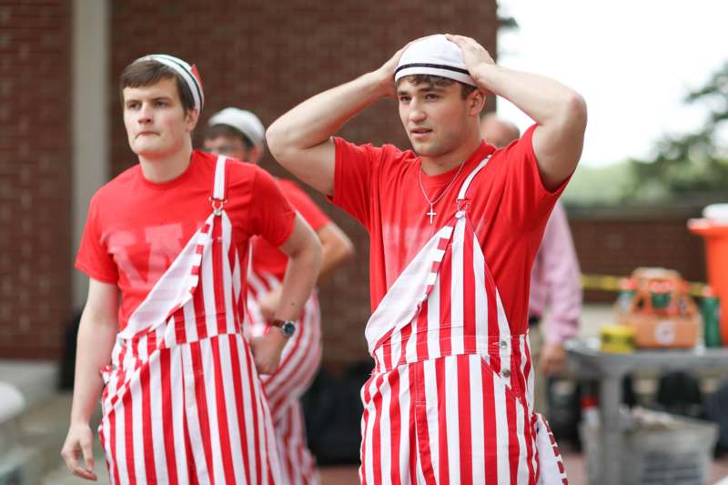 a group of men in striped overalls