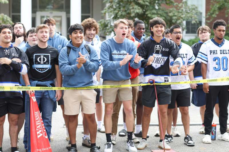 a group of people standing in front of a yellow tape