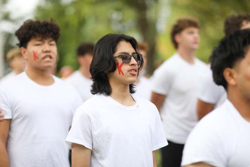 a group of people in white shirts