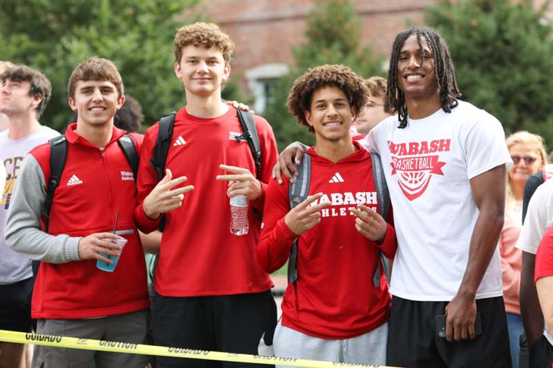 a group of young men in red shirts