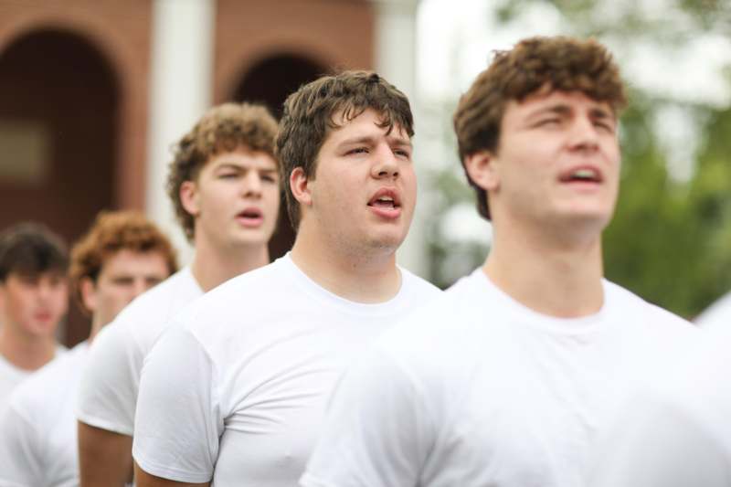 a group of men in white shirts