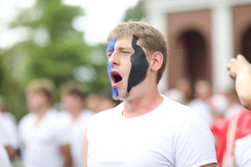 a man with his mouth open with black paint on his face