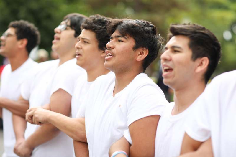 a group of men in white shirts