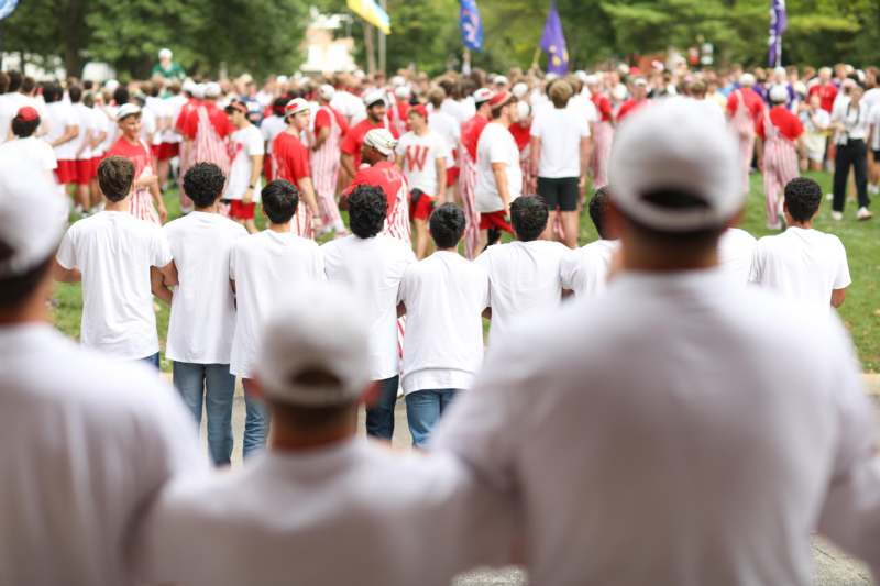 a group of people in white shirts