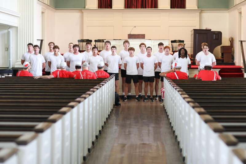 a group of people in white shirts