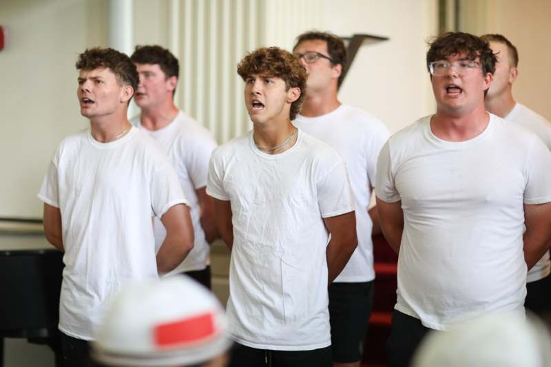 a group of men wearing white shirts