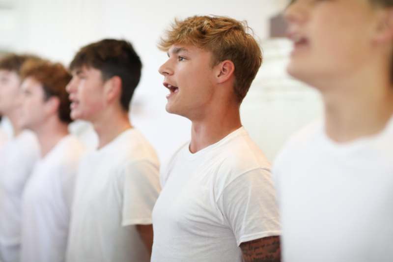 a group of men in white shirts