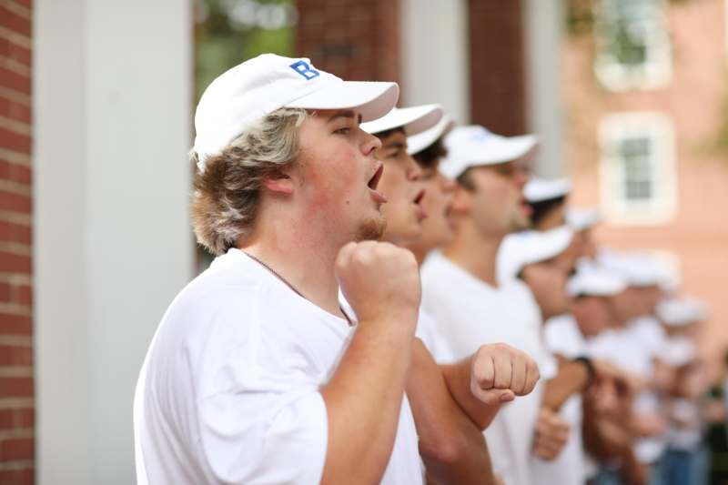a group of men wearing white shirts and hats
