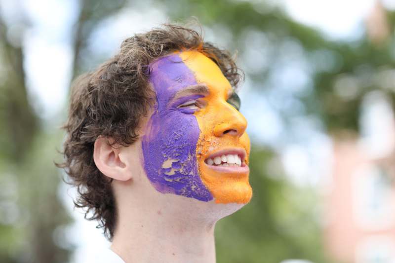 a man with orange and purple paint on his face