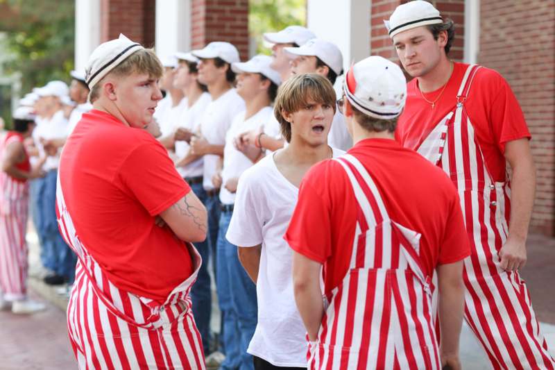 a group of people wearing striped outfits