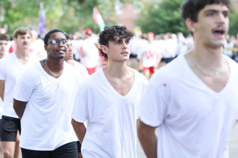 a group of men in white shirts