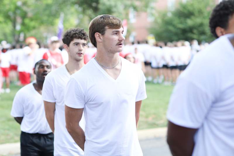 a group of men in white shirts