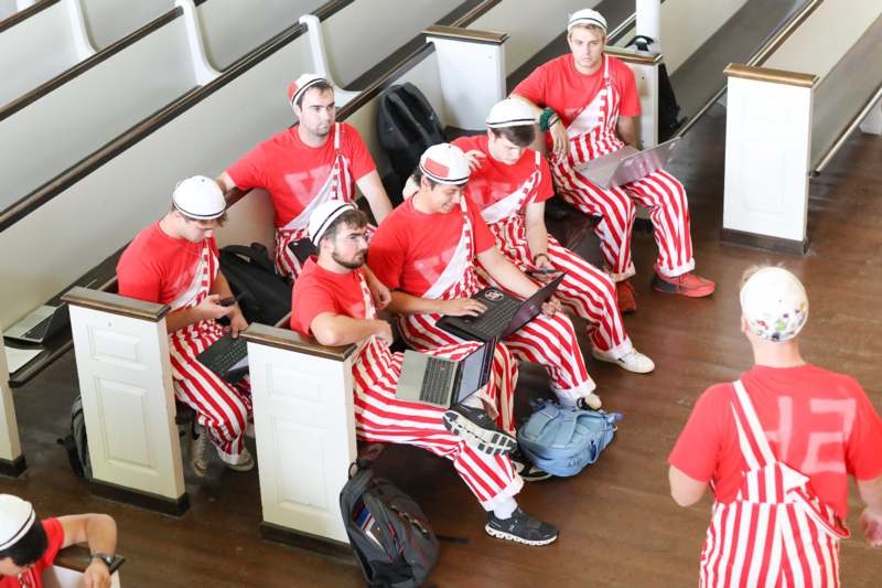 a group of men in striped red and white outfits
