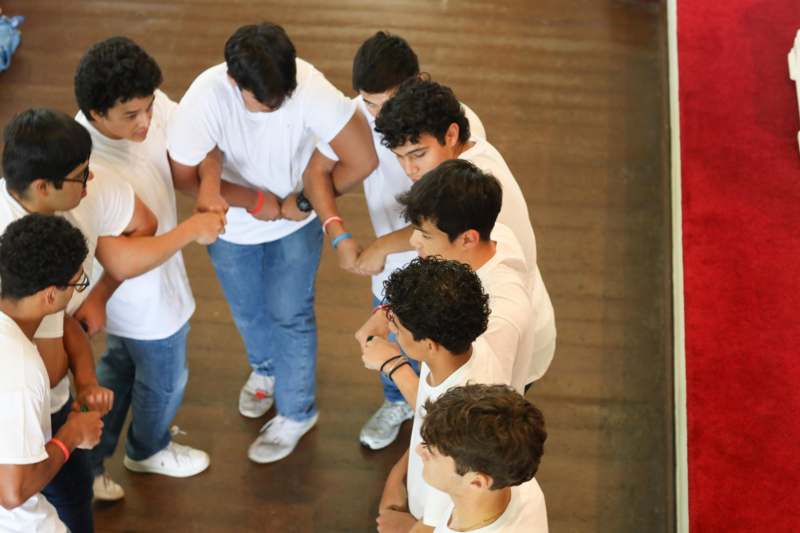 a group of people in white shirts