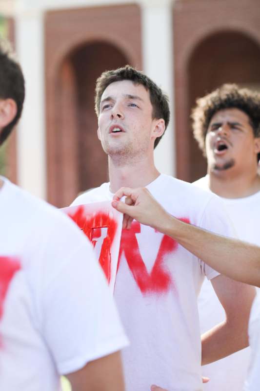 a group of men wearing white shirts