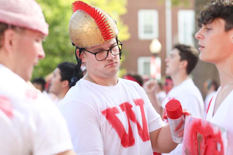 a man wearing a gold and red helmet