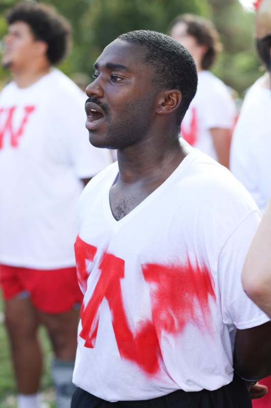 a man in a white shirt with red letters