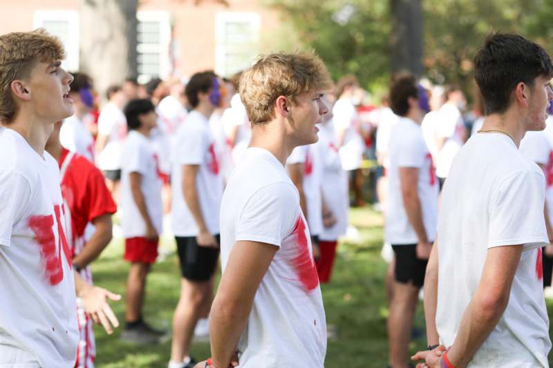 a group of people in white t-shirts