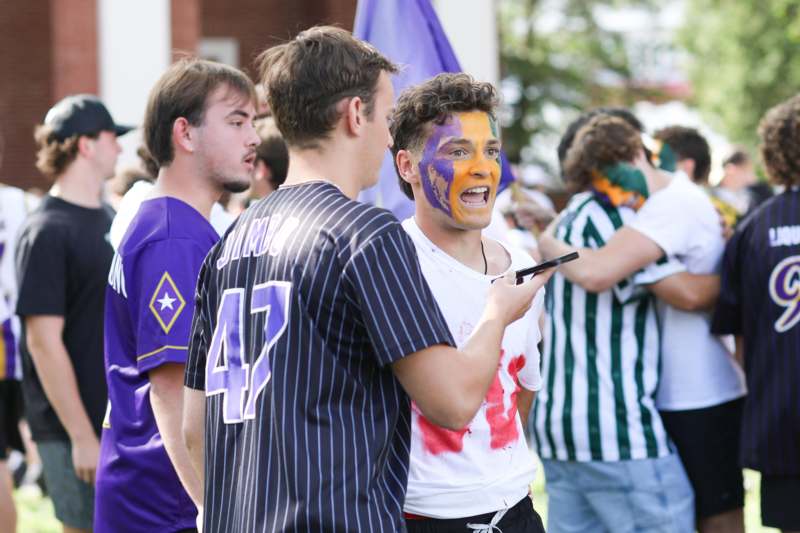 a man with face paint and a group of people