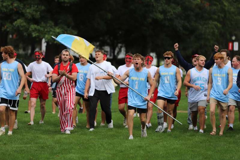 a group of people running on grass