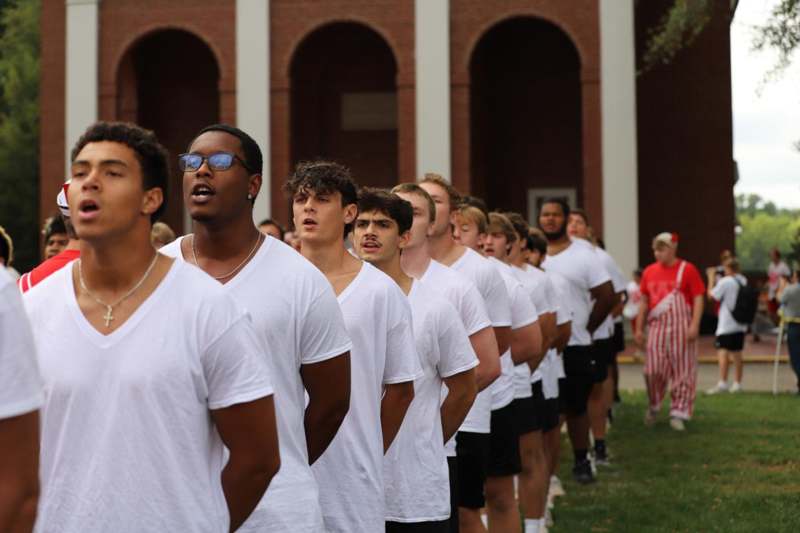 a group of people in white shirts