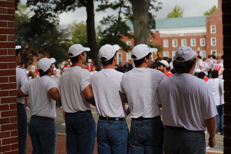 a group of men wearing white shirts and white hats
