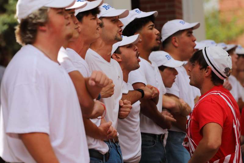 a group of men in white shirts