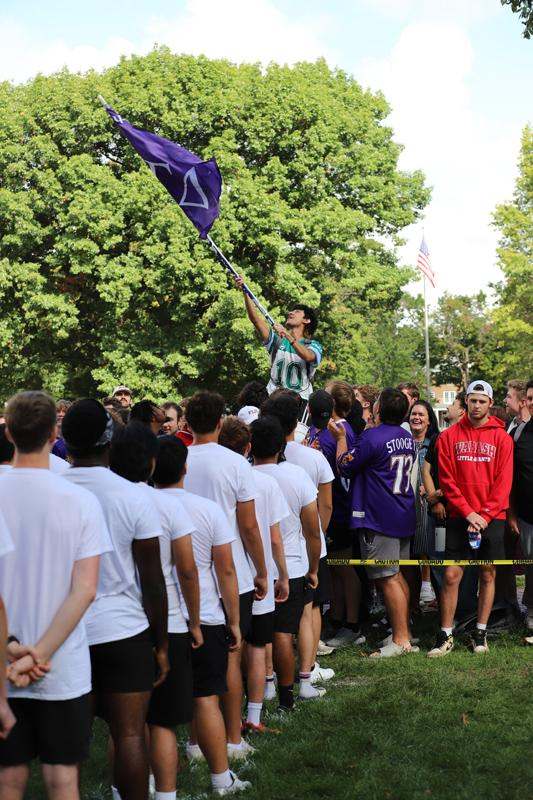 a man holding a flag in front of a crowd of people