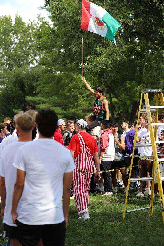 a man on a pole holding a flag