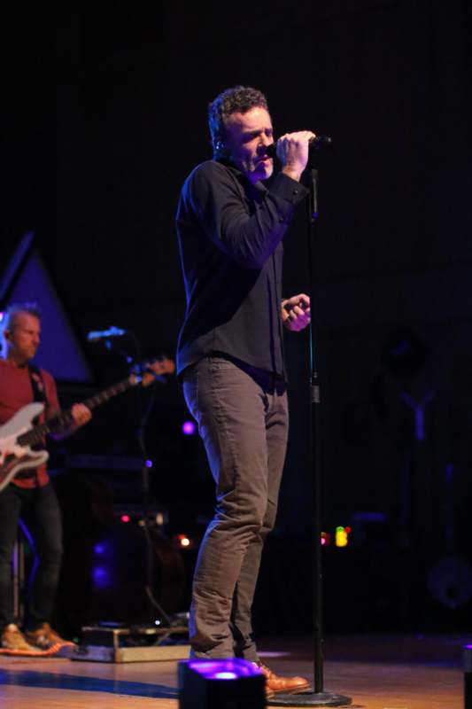 a man singing into a microphone